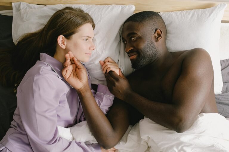 Couple discussing sex vs couples therapy options while lying in bed
